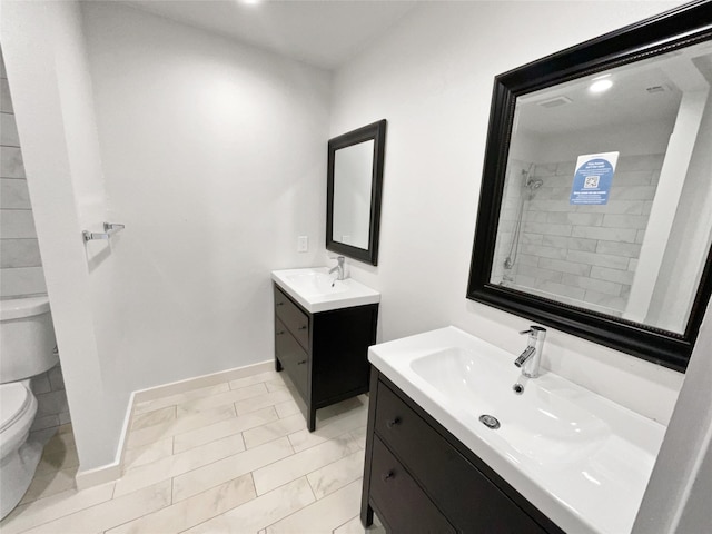 bathroom featuring toilet, tile patterned floors, and vanity