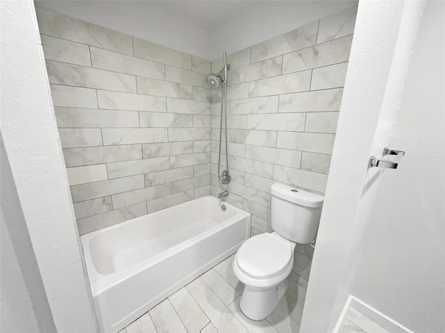 bathroom with tiled shower / bath combo and toilet