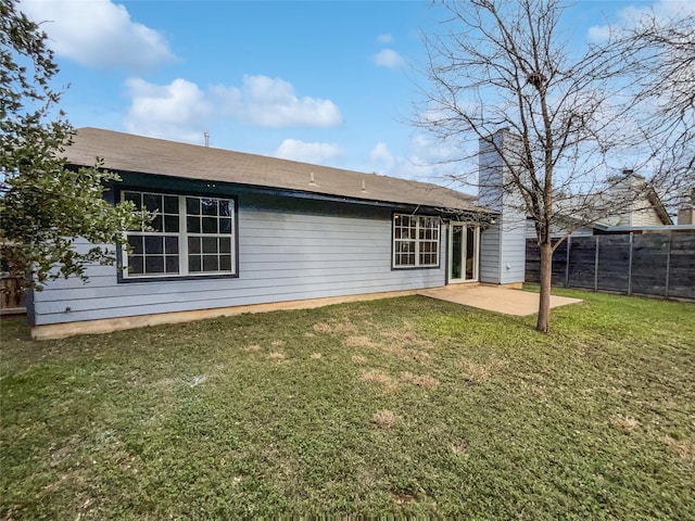 back of property with a patio and a lawn