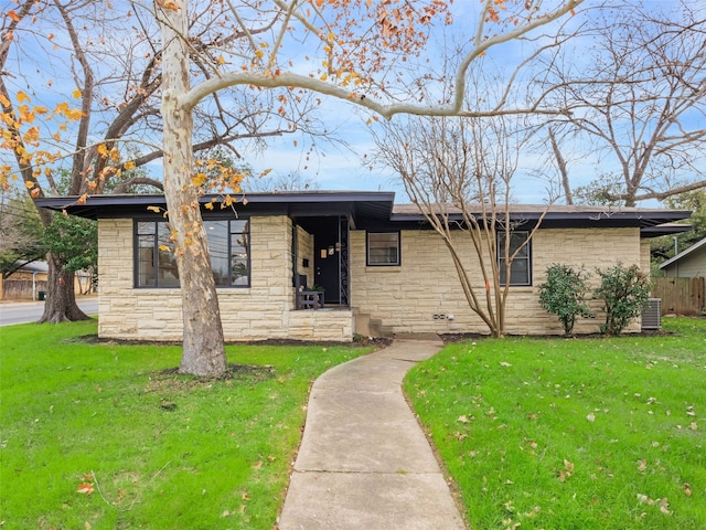 single story home featuring a front lawn and central AC