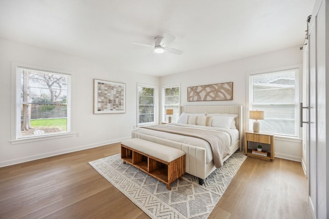 bedroom featuring baseboards, ceiling fan, and wood finished floors
