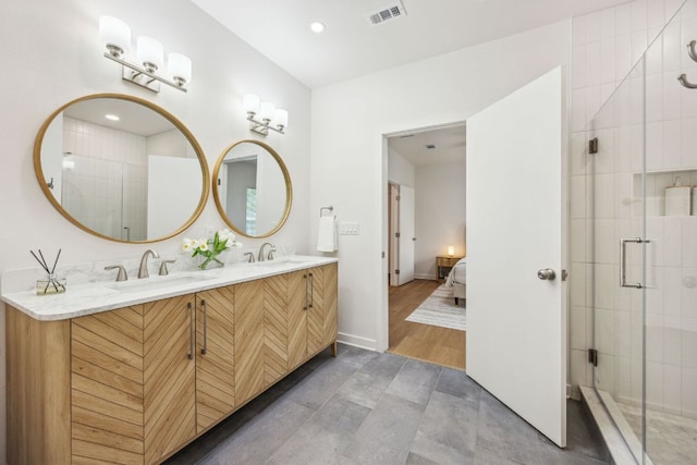 ensuite bathroom featuring visible vents, a sink, ensuite bathroom, and a stall shower