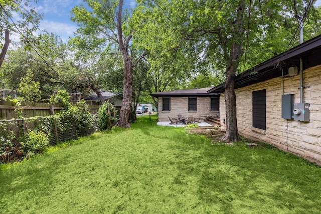 view of yard featuring a patio and fence