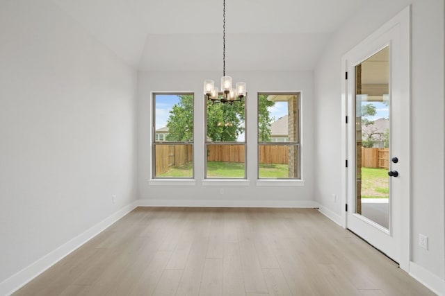 314 Five Mile Creek Way, Kyle, TX 78640 - unfurnished dining area featuring a chandelier, vaulted ceiling, baseboards, and light wood-style flooring