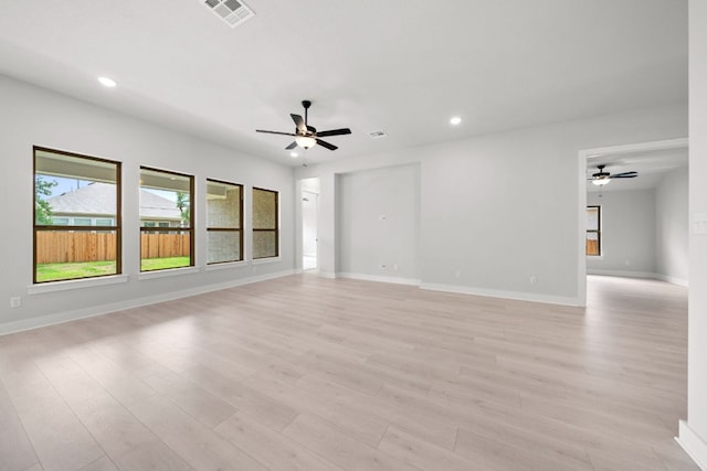314 Five Mile Creek Way, Kyle, TX 78640 - unfurnished living room featuring ceiling fan, recessed lighting, light wood finished floors, and baseboards