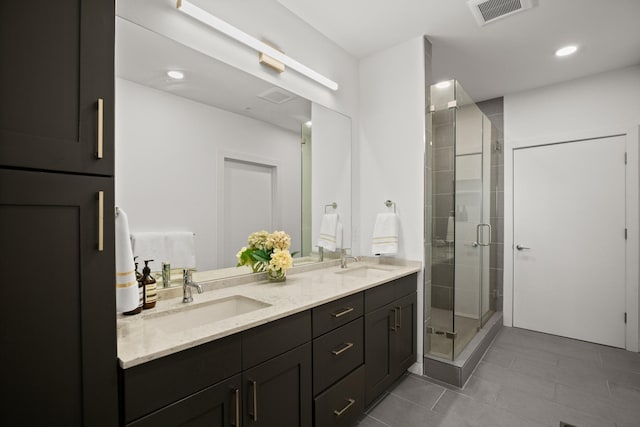 bathroom featuring vanity, tile patterned flooring, and walk in shower