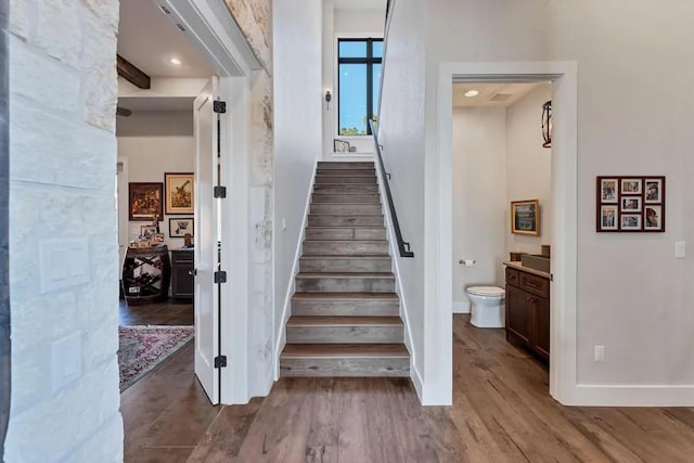 stairs with hardwood / wood-style floors