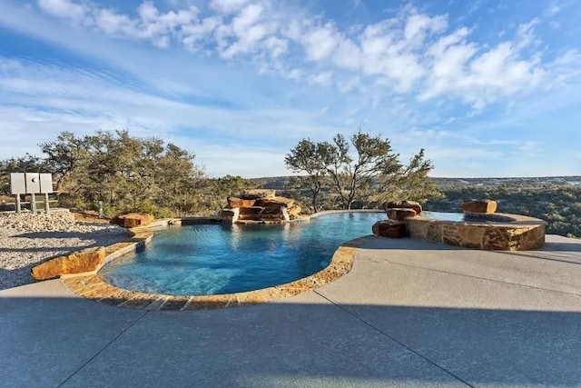 view of swimming pool featuring a patio area and a hot tub