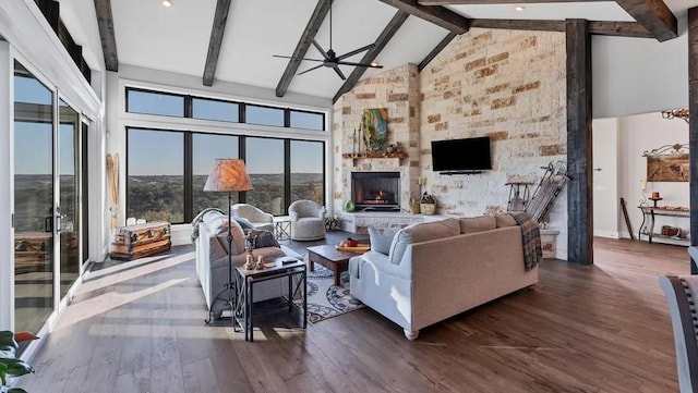 living room with high vaulted ceiling, dark wood-type flooring, beamed ceiling, and a fireplace