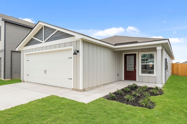 ranch-style house featuring a garage and a front lawn