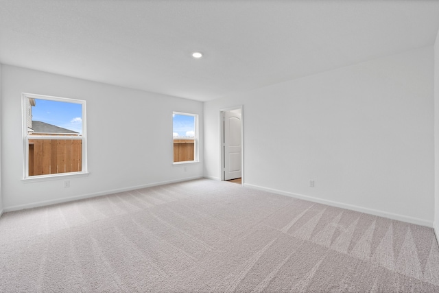 unfurnished room with light carpet