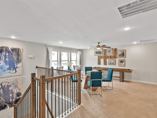 interior space featuring ceiling fan and light carpet