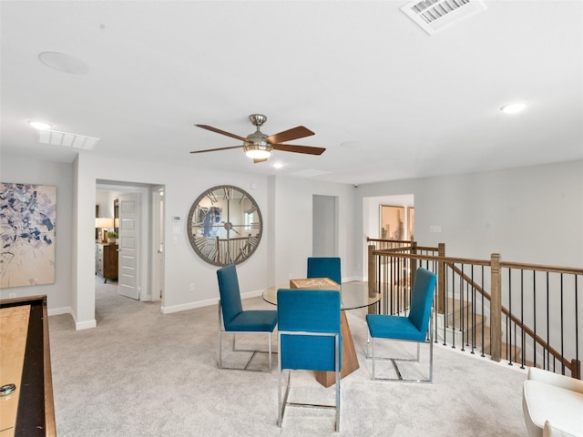 living area with ceiling fan and light colored carpet