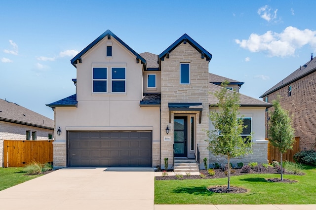 184 Milam Creek Dr, Kyle, TX 78640 - view of front of home with stucco siding, stone siding, an attached garage, and driveway