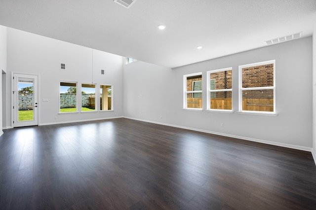 184 Milam Creek Dr, Kyle, TX 78640 - unfurnished living room with healthy amount of natural light, baseboards, dark wood-style floors, and recessed lighting