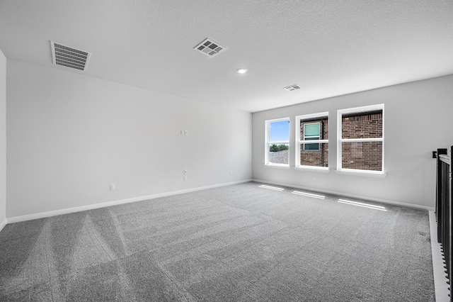 184 Milam Creek Dr, Kyle, TX 78640 - carpeted empty room featuring baseboards, a textured ceiling, and recessed lighting