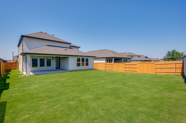 184 Milam Creek Dr, Kyle, TX 78640 - back of house featuring a shingled roof, stucco siding, and a patio