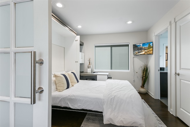 bedroom with dark wood-type flooring