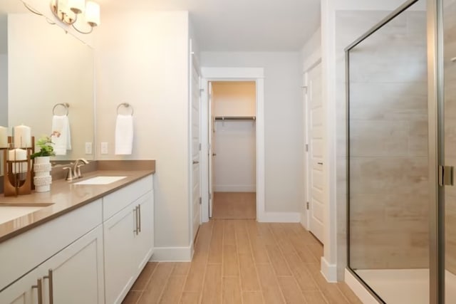 bathroom with an enclosed shower, vanity, and hardwood / wood-style floors