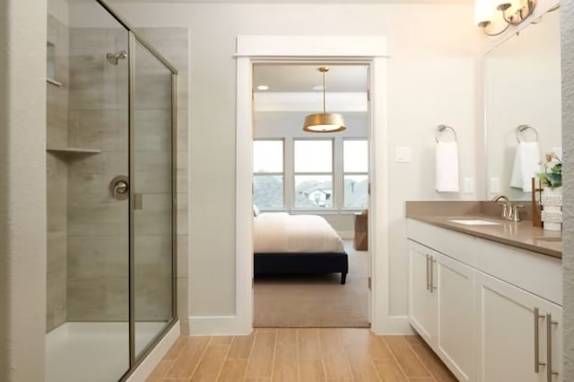 bathroom featuring vanity and a shower with door