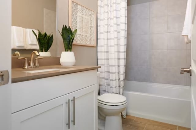 full bathroom with toilet, vanity, and shower / tub combo with curtain