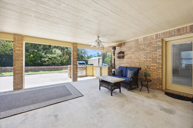 view of patio / terrace featuring a grill, outdoor lounge area, ceiling fan, and an outdoor kitchen