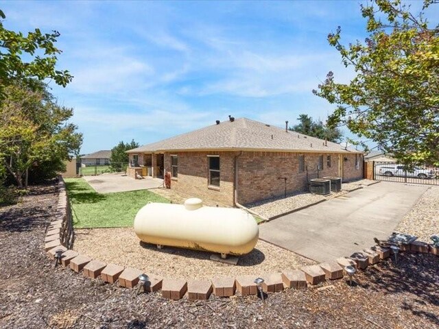 back of property featuring central air condition unit and a patio area