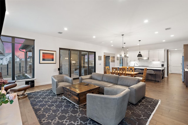 living room featuring dark hardwood / wood-style flooring and sink