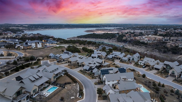 aerial view at dusk with a water view