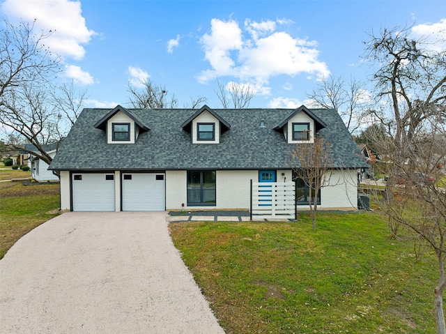 new england style home with a garage and a front lawn