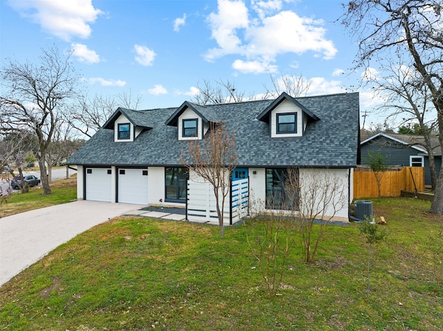 cape cod home featuring a garage, central AC, and a front lawn