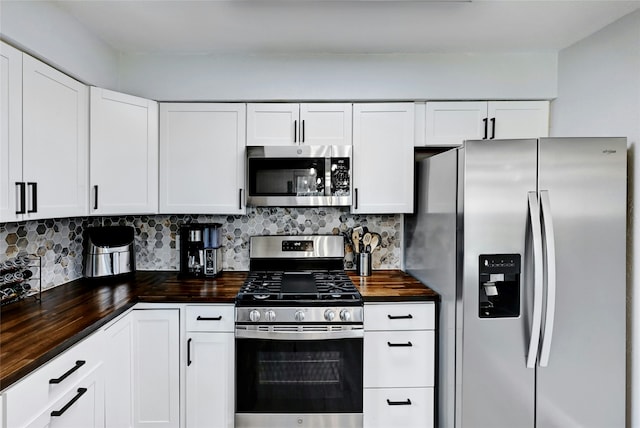 kitchen featuring white cabinets, stainless steel appliances, and tasteful backsplash