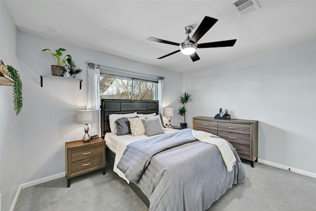 bedroom with ceiling fan and light colored carpet