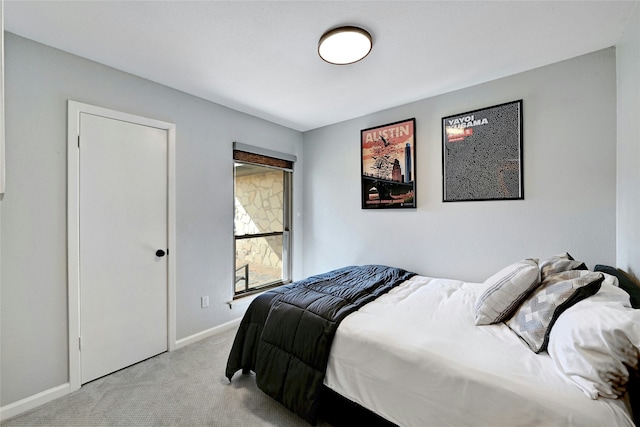 bedroom featuring light colored carpet