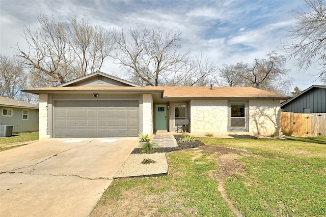 single story home with a garage, a front lawn, and central air condition unit