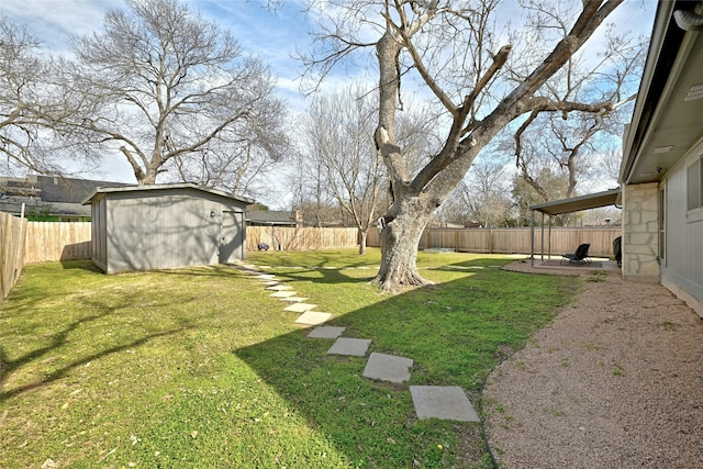 view of yard with a storage shed and a patio