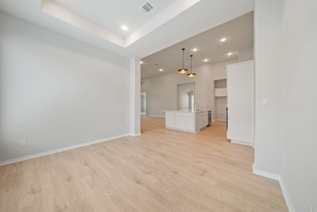 305 Five Mile Creek Way, Kyle, TX 78640 - unfurnished living room featuring light wood-style floors, recessed lighting, baseboards, and a sink