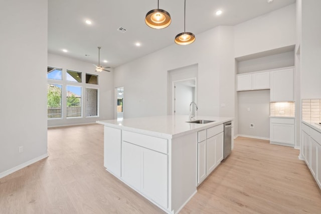 305 Five Mile Creek Way, Kyle, TX 78640 - kitchen with a sink, a ceiling fan, light wood-style floors, white cabinets, and recessed lighting