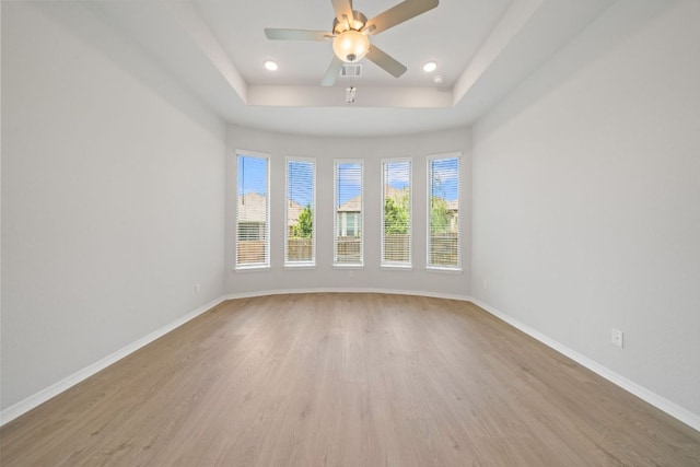 305 Five Mile Creek Way, Kyle, TX 78640 - spare room with light wood-type flooring, a tray ceiling, baseboards, and recessed lighting