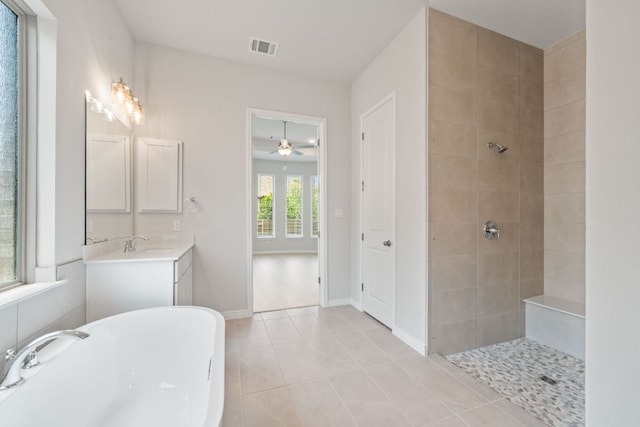 305 Five Mile Creek Way, Kyle, TX 78640 - bathroom with a freestanding tub, a tile shower, ceiling fan, tile patterned flooring, and vanity