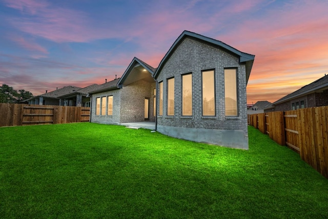 305 Five Mile Creek Way, Kyle, TX 78640 - back of property at dusk featuring brick siding