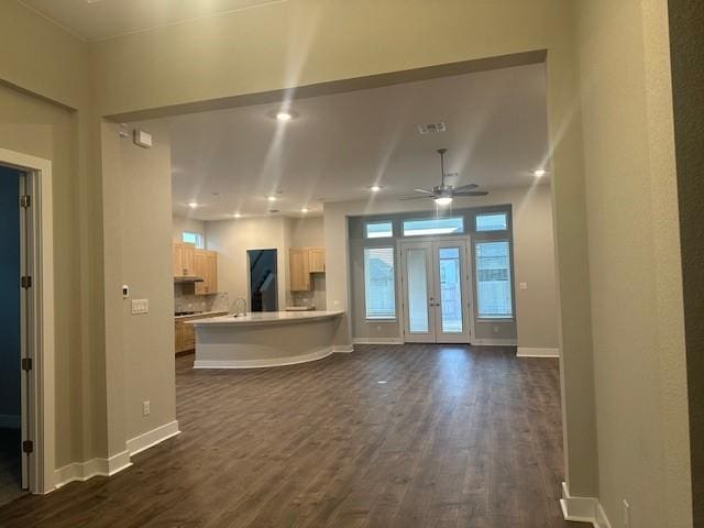 interior space featuring ceiling fan and dark hardwood / wood-style floors