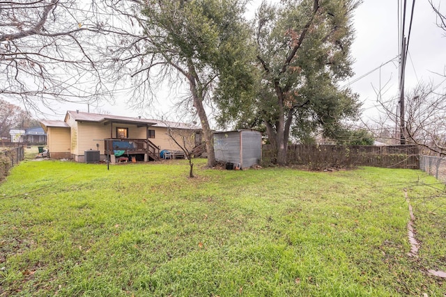 view of yard with central AC unit and a storage shed