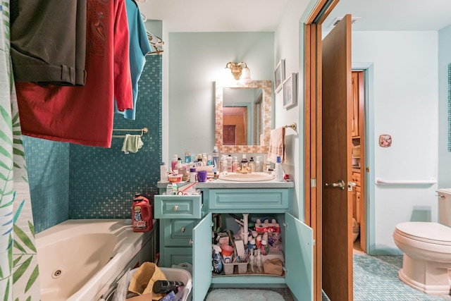 bathroom with a washtub, toilet, and vanity