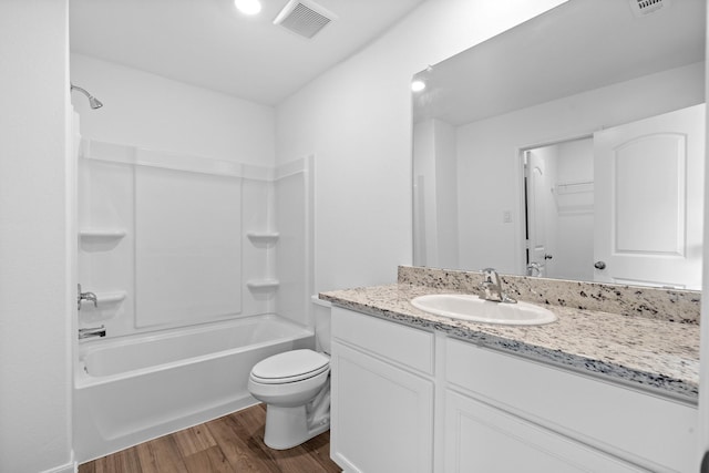 full bathroom with toilet, hardwood / wood-style floors, vanity, and bathtub / shower combination