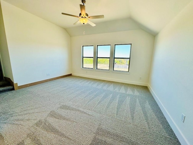 carpeted spare room with lofted ceiling and ceiling fan