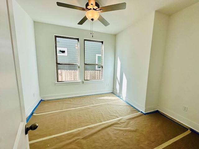 carpeted spare room with ceiling fan