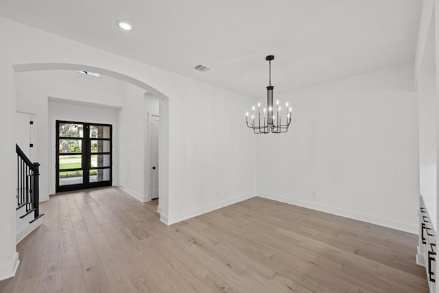 162 Leaning Rock Rdg, Austin, TX 78737 - unfurnished dining area with arched walkways, light wood finished floors, a chandelier, stairway, and recessed lighting