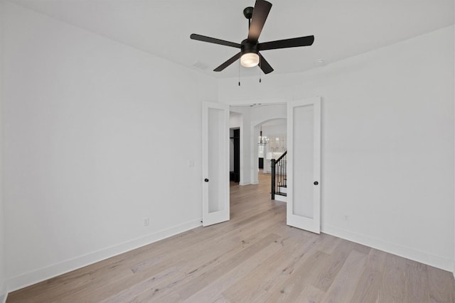 162 Leaning Rock Rdg, Austin, TX 78737 - unfurnished room with arched walkways, ceiling fan, and light wood finished floors