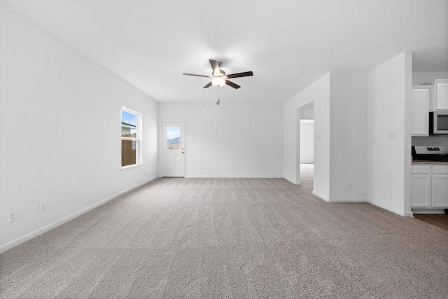 unfurnished living room with light carpet and ceiling fan